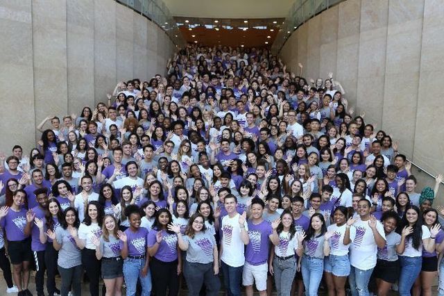 A large crowd of NYU Resident Assistants and Resource Center Assistants pose for a photo.
